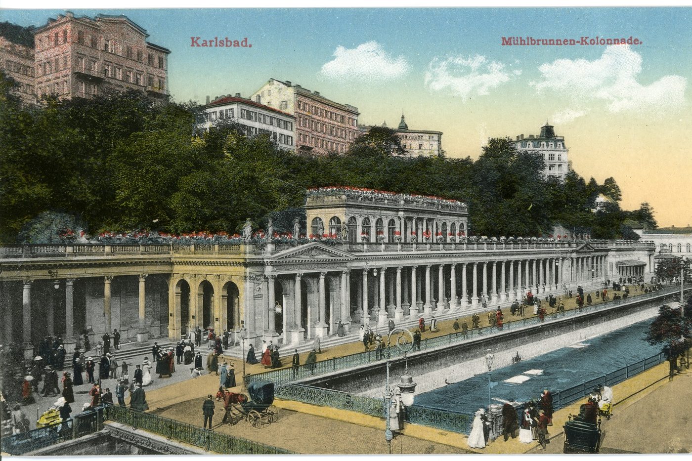 An old coloured postcard of a long spa colonnade with visitors strolling